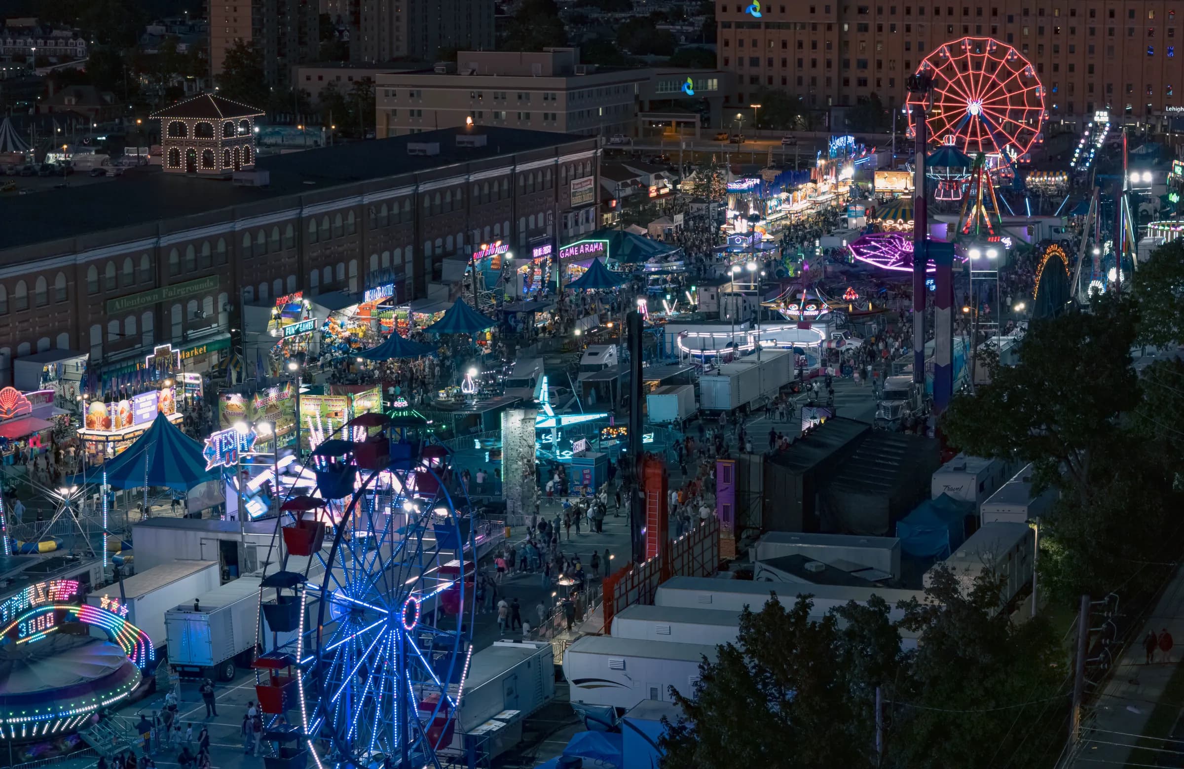 The Allentown Fair midway and rides lit up at night from above