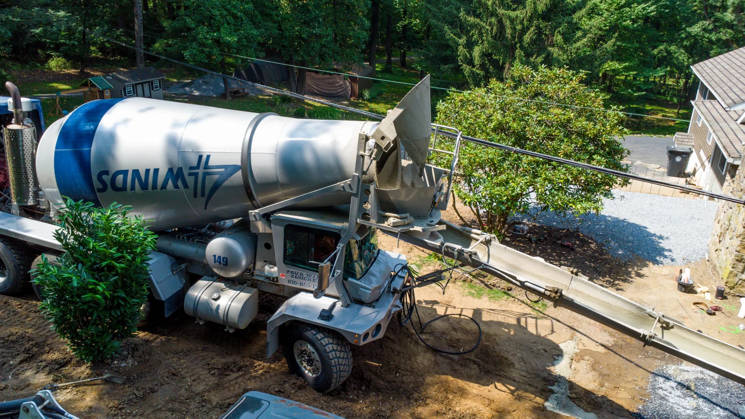 Concrete mixer truck pouring at a residential job site, photographed from above