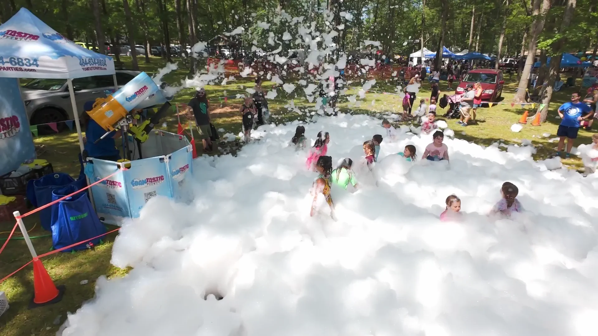 Aerial view of children and families at an outdoor foam event