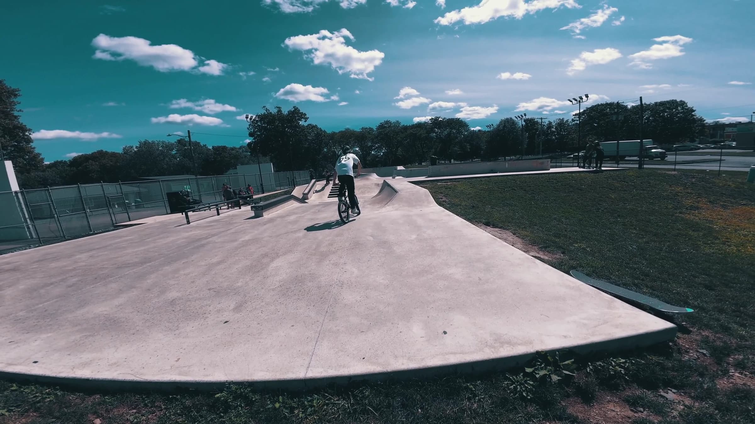 FPV drone following a BMX rider through a skatepark